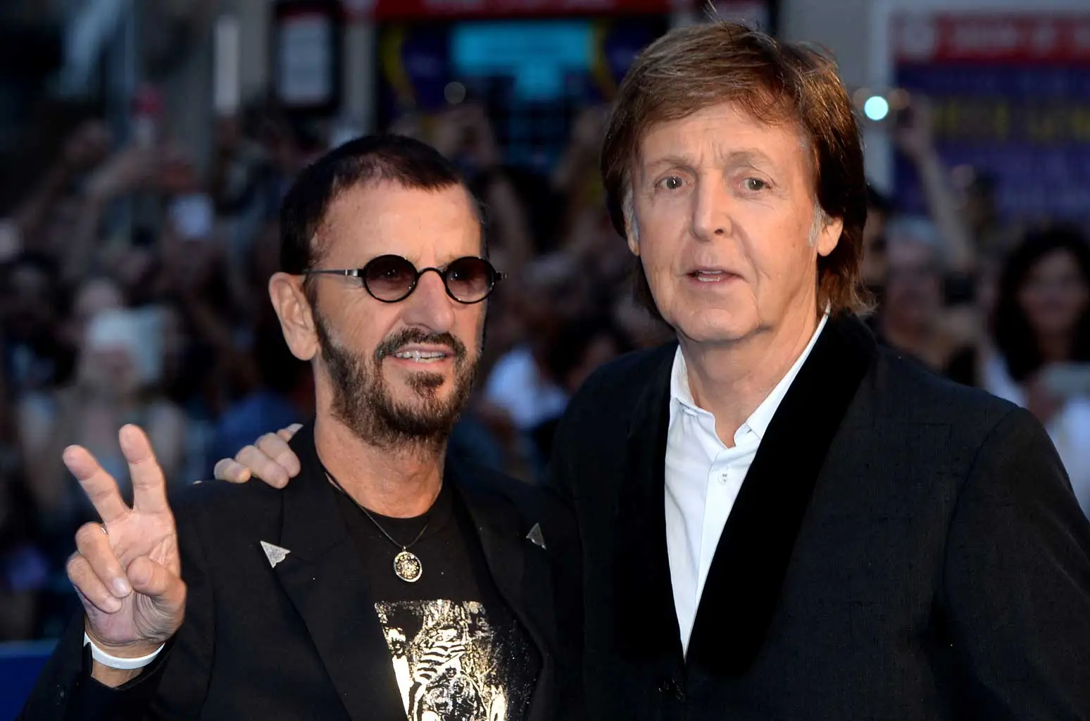 Paul McCartney and Ringo Starr performing together, celebrating their surprise new duet "Home to Us"