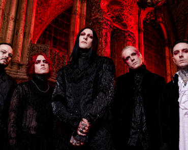 Motionless In White performing live on stage under red lighting during a recent tour