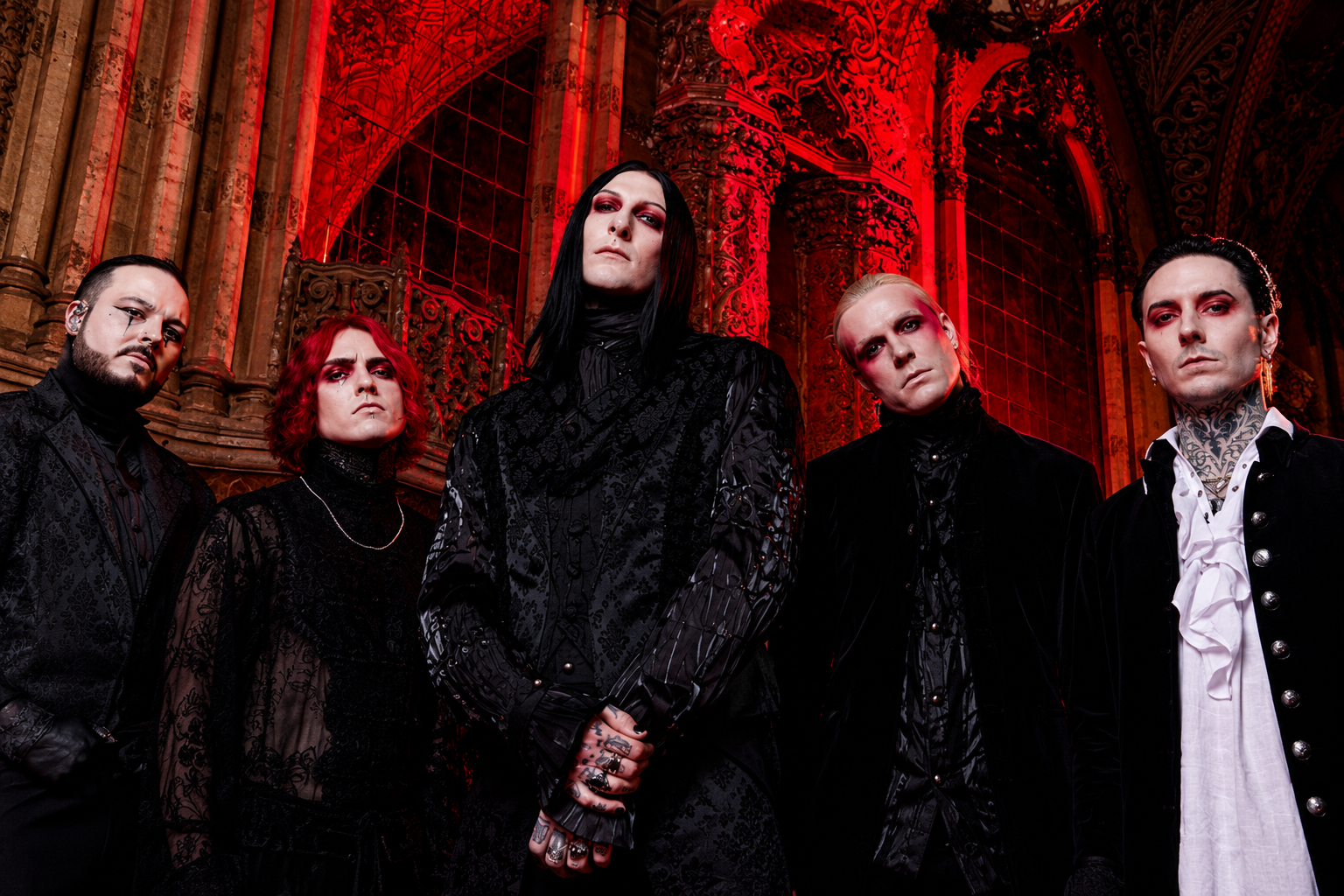 Motionless In White performing live on stage under red lighting during a recent tour
