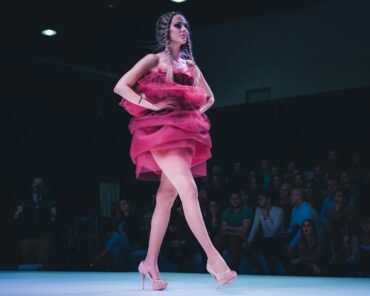 A front-row seat at a Fashion Week runway show, representing the growing crossover between the music and fashion industries