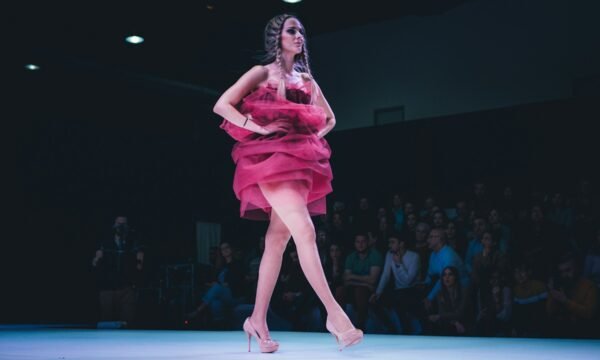 A front-row seat at a Fashion Week runway show, representing the growing crossover between the music and fashion industries