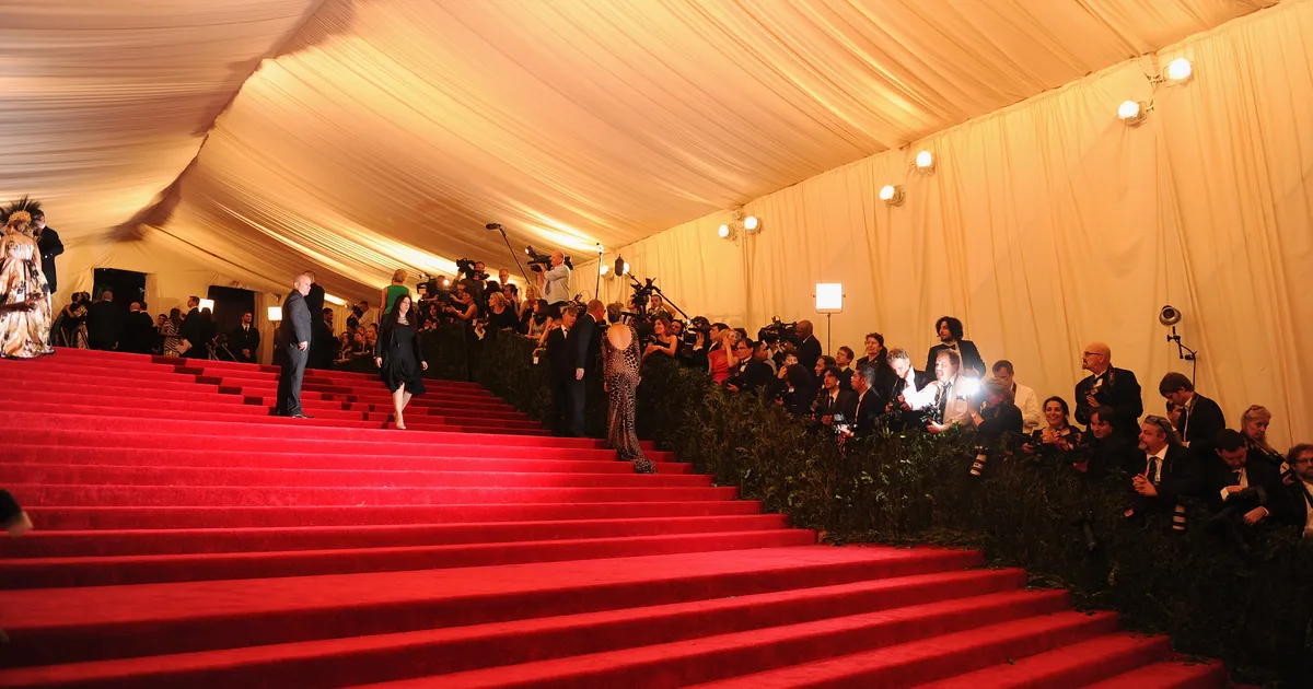 A dramatic Met Gala red carpet look worn by a musician, representing the most iconic designer collaborations in music fashion history