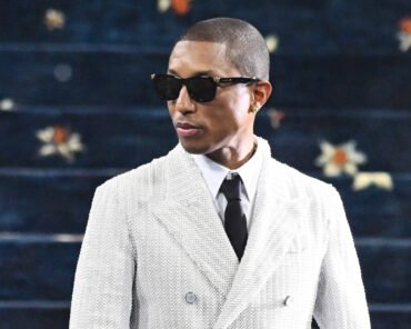 Pharrell Williams speaking during an interview, representing his views on crossing between music and fashion