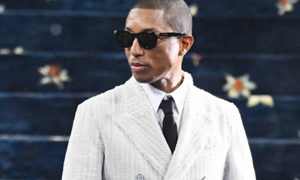 Pharrell Williams speaking during an interview, representing his views on crossing between music and fashion