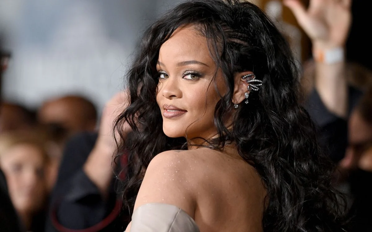 Rihanna speaking during an interview, representing her comments on balancing music and her beauty business