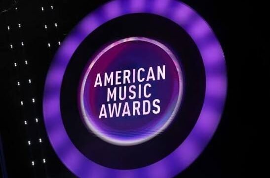 A smartphone displaying an American Music Awards voting screen, representing the ceremony's fan-driven voting process