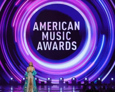 A host on stage at a major music awards show, representing some of the most memorable hosting moments in the genre's history