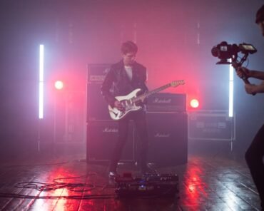 A stylized still from a music video featuring a bold fashion look, representing some of music's most iconic video fashion moments