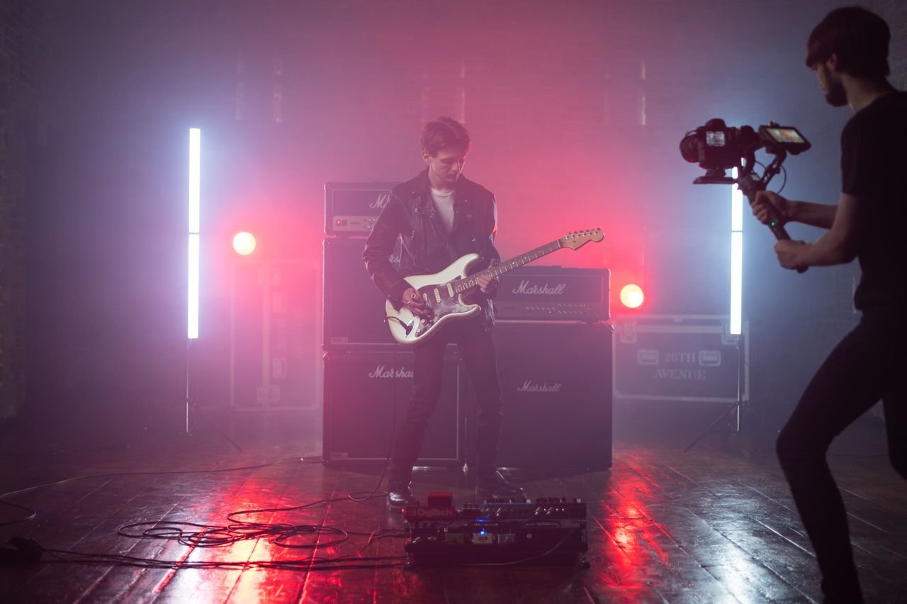 A stylized still from a music video featuring a bold fashion look, representing some of music's most iconic video fashion moments