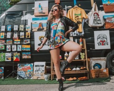 Designer tour merchandise displayed alongside streetwear pieces, representing music merch's crossover into high fashion