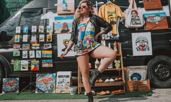 Designer tour merchandise displayed alongside streetwear pieces, representing music merch's crossover into high fashion