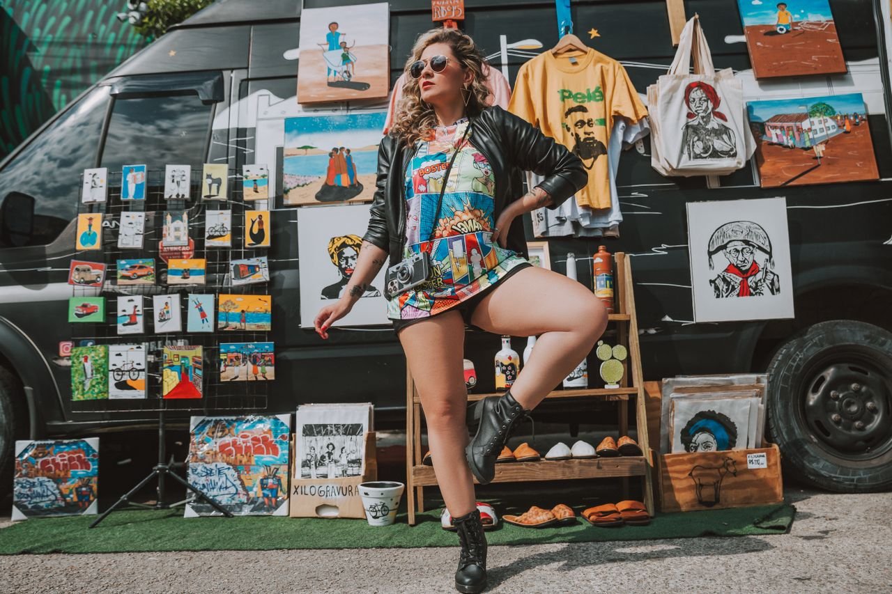 Designer tour merchandise displayed alongside streetwear pieces, representing music merch's crossover into high fashion
