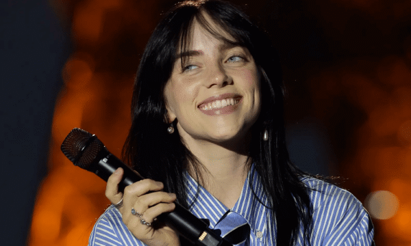 Billie Eilish performing live, illustrating her rise from bedroom recordings to major pop stardom