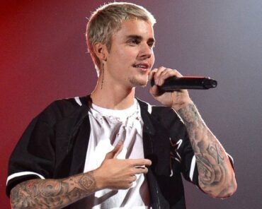 Justin Bieber performing on stage, representing his career from child star to adult solo artist