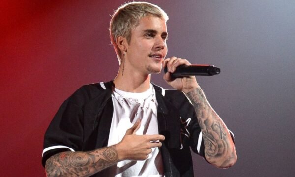 Justin Bieber performing on stage, representing his career from child star to adult solo artist