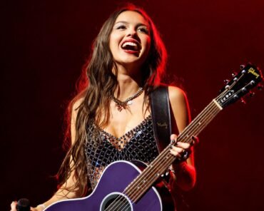 Olivia Rodrigo performing on stage, representing her rapid rise to pop stardom