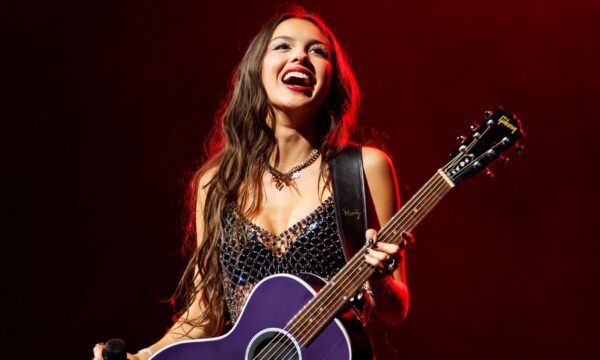 Olivia Rodrigo performing on stage, representing her rapid rise to pop stardom