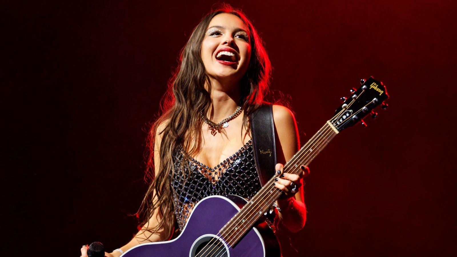 Olivia Rodrigo performing on stage, representing her rapid rise to pop stardom