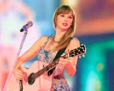 Taylor Swift performing on stage during a stadium tour, representing her career timeline retrospective