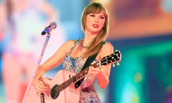 Taylor Swift performing on stage during a stadium tour, representing her career timeline retrospective