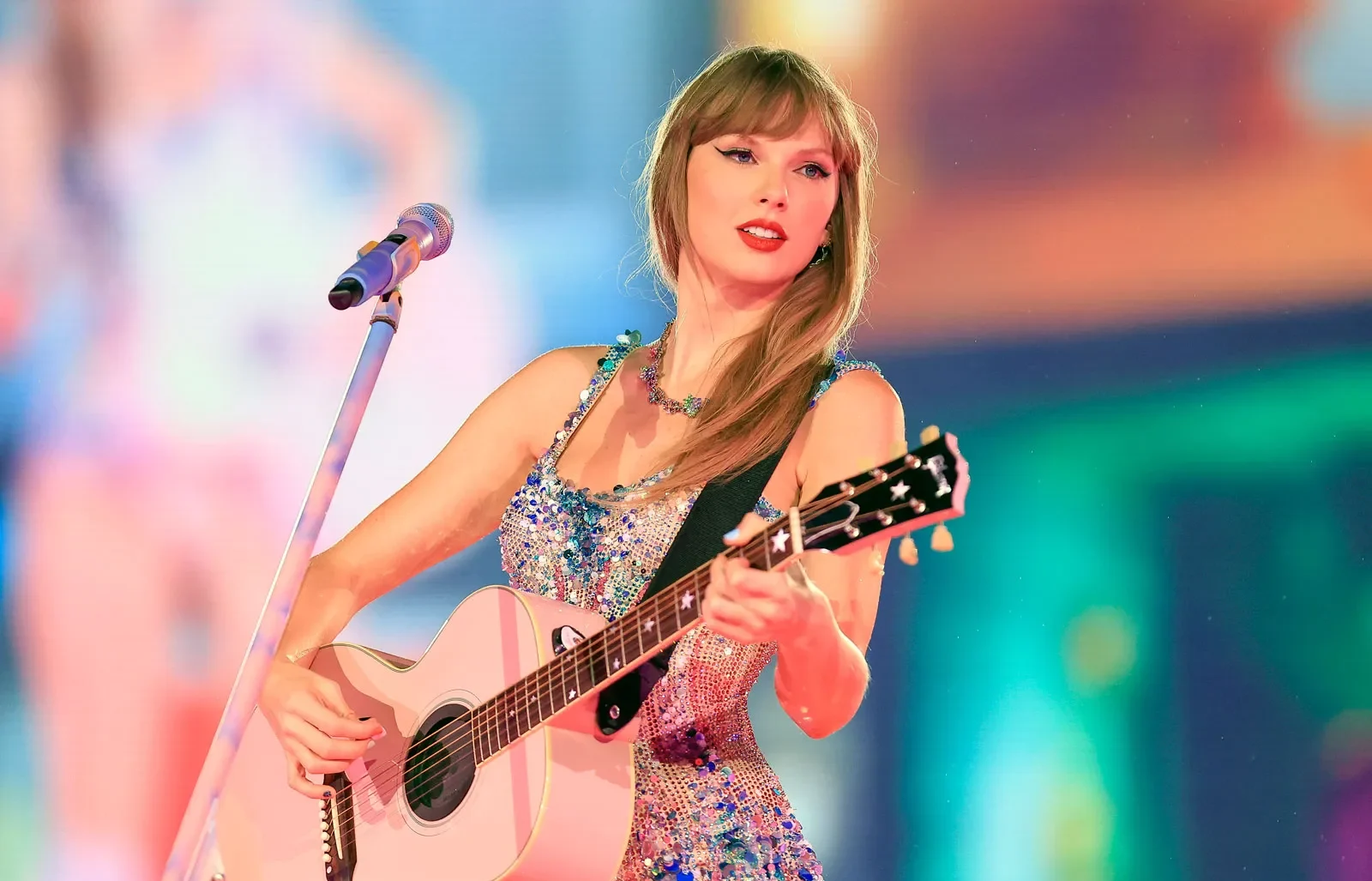 Taylor Swift performing on stage during a stadium tour, representing her career timeline retrospective